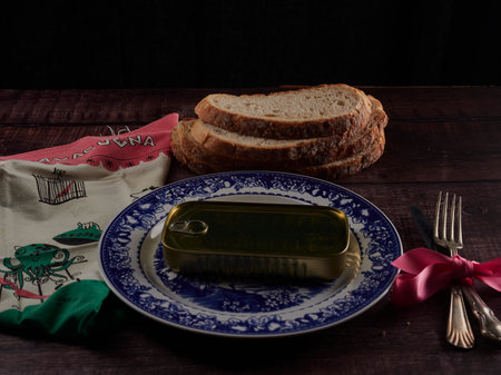 Picture of a tin can on a table with cutlery and napkin