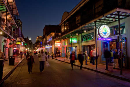 NEW ORLEANS, USA - CIRCA MARCH 2008: Crowds of people walking down Bourbon Street past the Cajun Cabin bar at dusk circa March 2008 in New Orleans, USAのeditorial素材