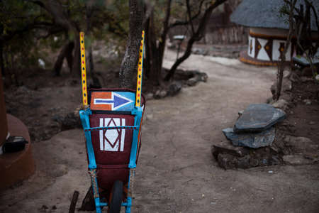 Right-pointing arrow painted on a traditional African wheelbarrowの写真素材