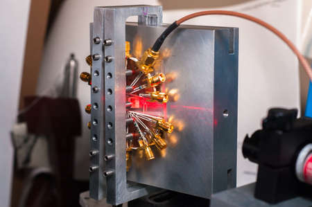 Optical device being hit by a red laser beam