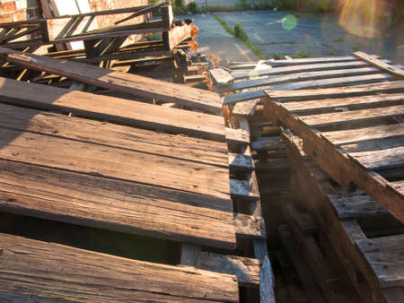 Wooden shipping pallets stacked as industrial trashの写真素材