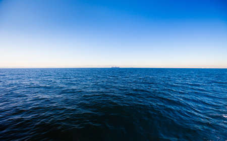 Still calm sea water surface and perfect skyの写真素材