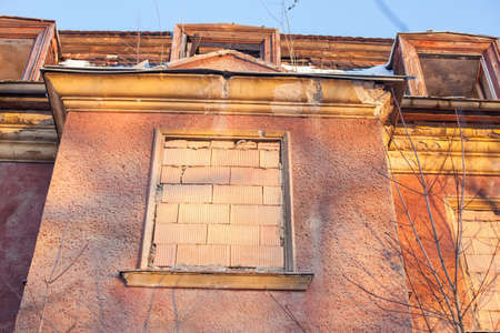 Abandoned house sealed with bricks in winterの写真素材