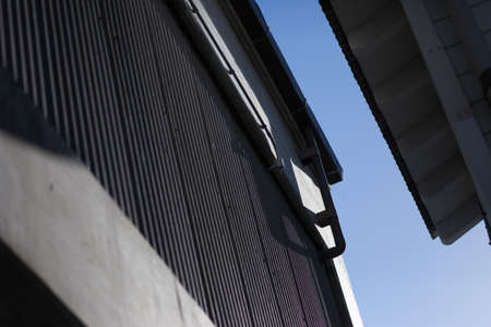 Downspout and gutters of building with corrugated steel walls