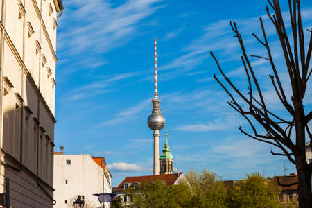 City neighborhood, church steeple, and TV Tower (Fernsehturm) in Berlin, Germanyのeditorial素材