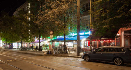 BERLIN - October 8, 2016: The cafes and bars at Rosenthaler Platz (Rosenthal Square) in Berlin's Prenzlauer Berg on the night of October 8, 2016.の写真素材
