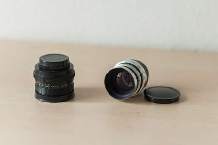 Vintage camera lenses on a wooden surface