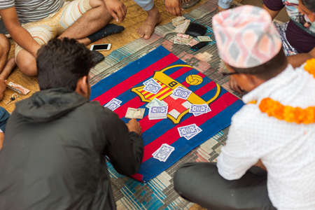 CHITWAN, NEPAL - 01 Nov 2016: Men gamble on the Falash (Teen Pathi) card game on November 1, 2016 in Chitwan, Nepalのeditorial素材