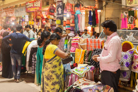 VARANASI, INDIA - 24 Oct 2016: Merchants and customers at the night market near Dasaswamedh Ghat on October 24, 2016 in Varanasi, Indiaのeditorial素材