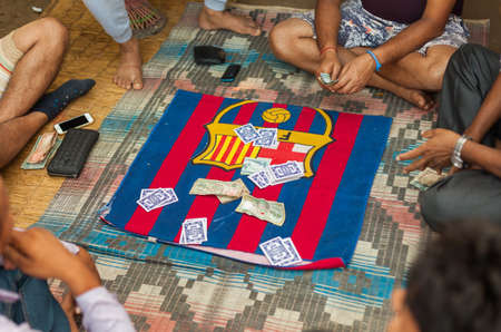 CHITWAN, NEPAL - 01 Nov 2016: Men gamble on the Falash (Teen Pathi) card game on November 1, 2016 in Chitwan, Nepalのeditorial素材