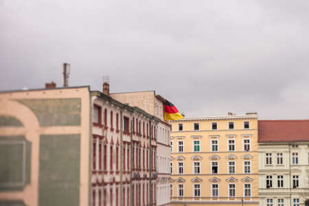 A German flag flies from the roof of an apartment building in Frankfurt (Oder) ahead of a right-wing protestの写真素材