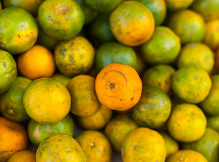 Green oranges on sale at a market, Nepalの写真素材