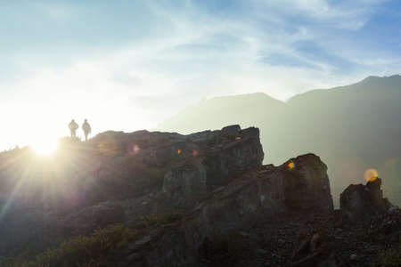 Hikers walk along the rim of the Ijen volcano crater on Java, Indonesia