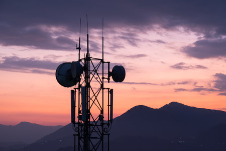 Antennas of a cell phone tower at sunsetの写真素材