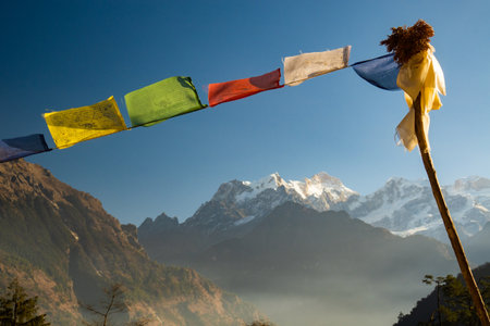 Prayer flags with a view of Manaslu Peak