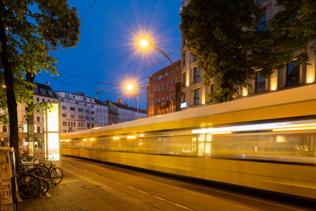 Traffic passes through Berlin's Rosenthaler Platz in the eveningの写真素材