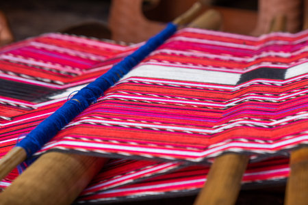 Brightly colored woven cloth on the loom at Tais market, Diliの写真素材