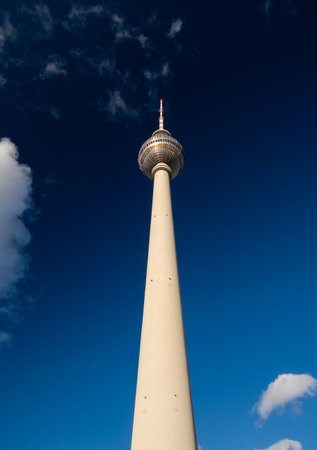 Berlin's iconic TV Tower against a blue sky from below