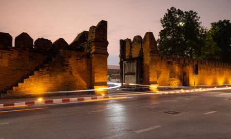 Traffic passes by Chiang Mai's iconic Tha Pae Gate, Thailandの写真素材