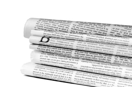 Stack of newspapers isolated on white backgroundの写真素材