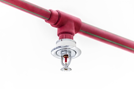 Fire sprinkler and red pipe on white ceiling backgroundの写真素材