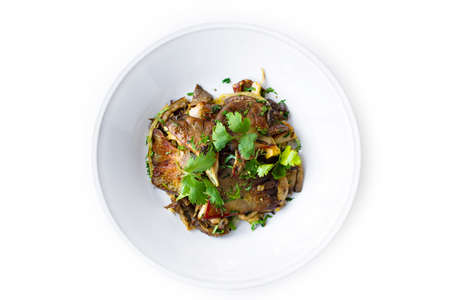 Fried mushroom slices plate with fresh herbs isolated on white backgroundの写真素材