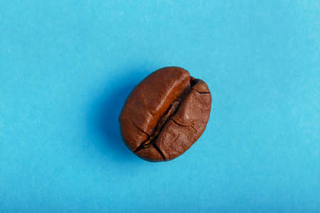 Coffee beans on a blue background close-upの写真素材