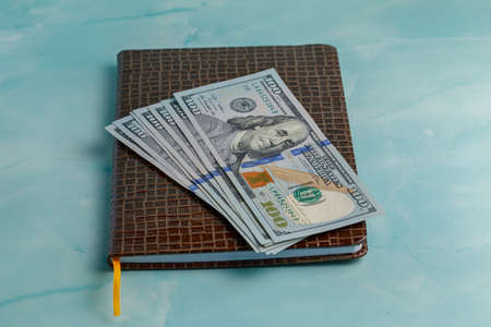 One hundred dollars banknote on a blue backgroundの写真素材