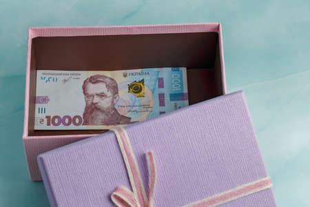 500 hryvnias lie on a textured turquoise background next to a deck of money hryvniasの写真素材