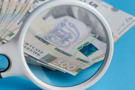 Deck 500 hryvnias deck through a magnifying glass closeup blue backgroundの写真素材