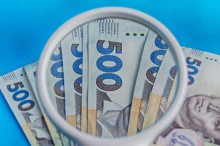 Deck 500 hryvnias deck through a magnifying glass closeup blue backgroundの写真素材
