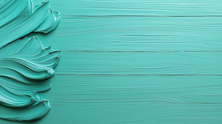 A smooth, vibrant turquoise paint covers a textured surface, showing a rich and lively color. The paint strokes flow harmoniously, inviting creativity and artistic expression.の素材