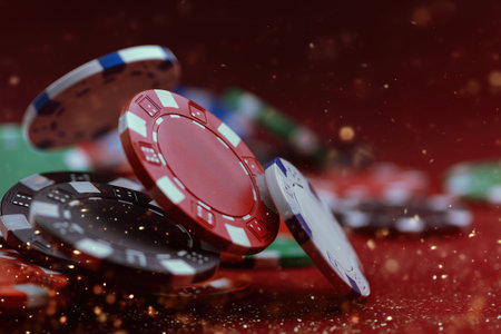 Colorful casino poker chips on red glitter background, gambling risk game and entertainment concept for casino ads, online platforms and financial articlesの素材