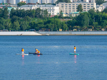 Active recreation on the board on the big river. Tourism on sap boards. outdoor water sports....