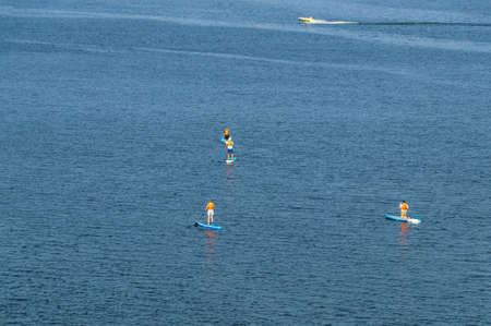 Active recreation on the board on the big river. Tourism on sap boards. outdoor water sports....