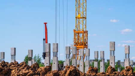 The foundation on reinforced concrete piles and the frame during the construction of a multi-storey building. Pouring of steel reinforcement of the building frame. Formwork of columns.の写真素材