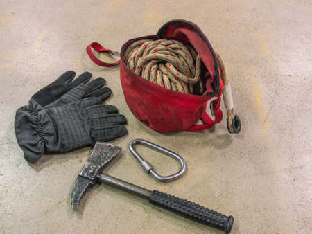 Gloves, boots and a fireman's axe. Firefighters' equipment. Special clothing to protect firefighters from injury. Means of rescue in case of fire at altitude.の写真素材