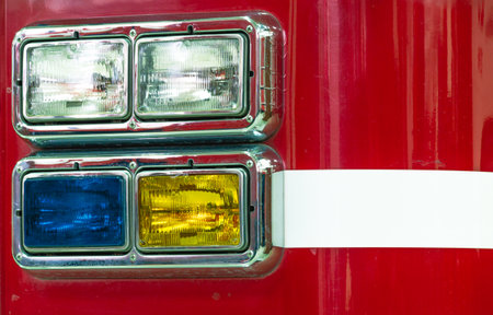 fire truck headlights. Yellow and blue headlights of a fire truck. White stripe on the fire truck.