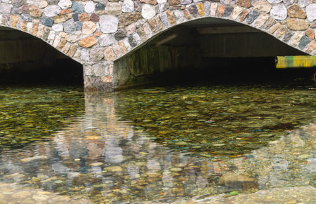 Clear water and stones near the arch of stones. clear water in karst lakeの写真素材