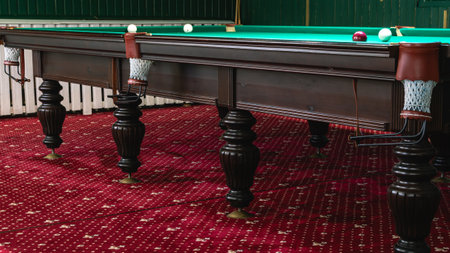 Billiard table with greencloth. billiard room. board game. Billiard club for relaxing in your free time. White balls on a green billiard table with pockets.の写真素材