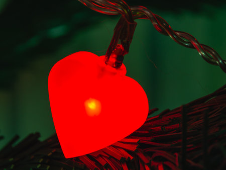 Burning red garland in the form of a heart