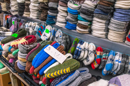 Knitwear made of natural wool. Wool socks for cold weather. Handmade products made of natural wool. Sale of warm clothes for winter.の写真素材