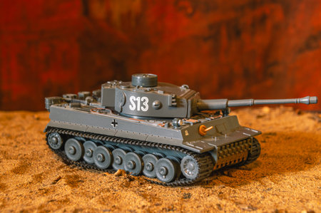 A toy model of a German tank that participated in the 2nd World War. German tank on yellow sand and...