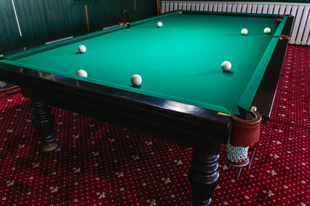 Billiard table with greencloth. billiard room. board game. Billiard club for relaxing in your free time. White balls on a green billiard table with pockets.の写真素材