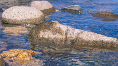 A mountain river with clear and transparent water. Landscape with a view of gray stones in a mountain river. Clean water and healthy water.の写真素材