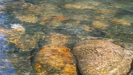 A mountain river with clear and transparent water. Landscape with a view of gray stones in a...