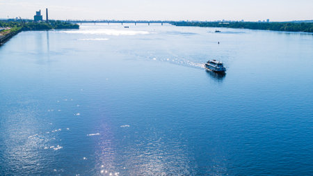 View of the river and a pleasure boat. The glare of the sun on the river water. river landscape in...
