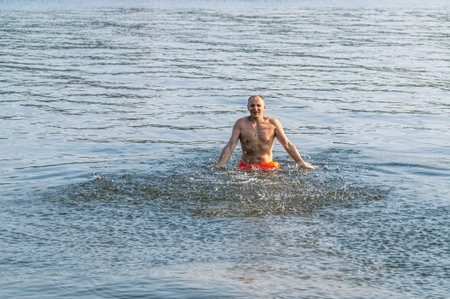Swimming in the river in summer. A man swims in the river and splashes. Beach holidays on the water....