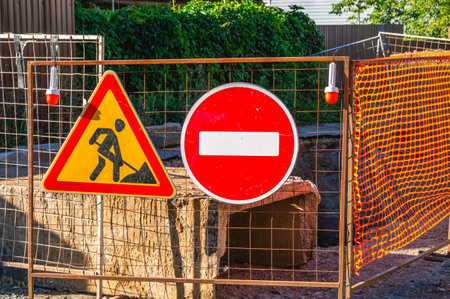 The road sign "Entry prohibited" prohibits traffic. road sign road works. The territory of the road is fenced due to repair work.の写真素材