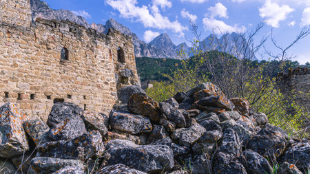Ruins of a medieval city. The wall of the ancient fortress is made of large stones. Masonry walls of...